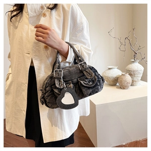 Detail of grey denim handbag with multi-pockets, heart mirror and retro Y2K styling