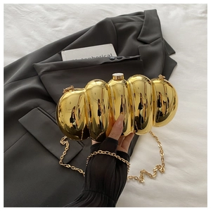 Detailed close-up of a gold mirrored segmented clutch bag with a sleek metal chain