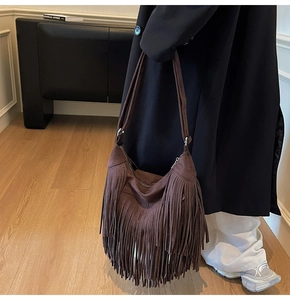 Close-up of the long fringes and textured matte finish on the vintage dark brown crossbody bag