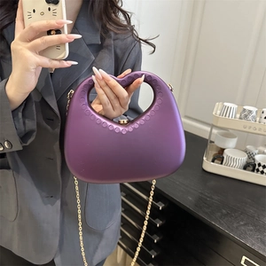 Purple heart-shaped cutout handbag with matte finish and elegant gold chain strap