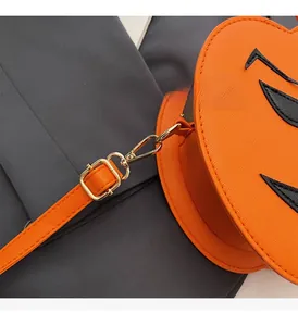 Detail of high-quality gold hardware on an orange pumpkin-shaped Halloween crossbody bag
