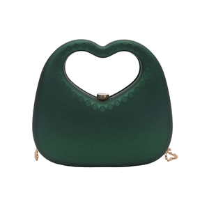 Dark green heart-shaped acrylic handbag with hollow handle and gold chain strap