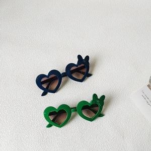 Kids heart shaped sunglasses with bows in navy and green featuring gradient lenses