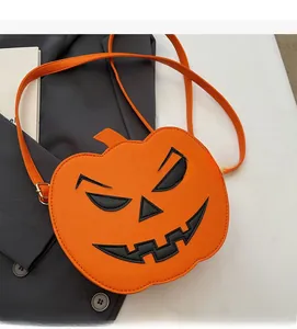 Close-up of orange pumpkin bag with black embroidery and lychee texture detail