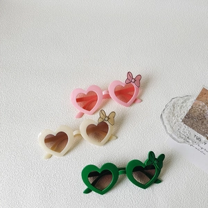 Kids heart-shaped sunglasses with cute bow accents in pink, beige and green colors