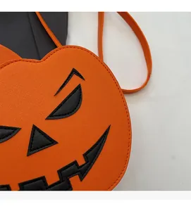 Close-up of orange cross-grain leather texture and pumpkin face stitching on the bag