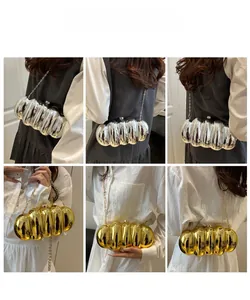 Detail of metallic acrylic clutch bag with vertical pleats in gold and silver colors