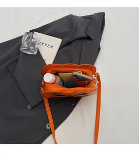 Macro shot of Halloween pumpkin bag showing spacious black interior and orange PU leather