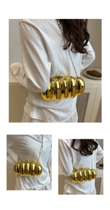 Detail of gold caterpillar acrylic evening bag with wave texture and chain strap