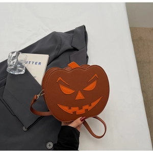 Détail du sac bandoulière en forme de citrouille avec visage effrayant et texture