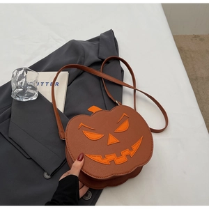 Detailed close-up of brown PU leather pumpkin crossbody bag with bright orange face detail