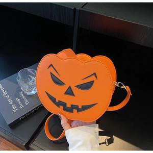 Detail of orange pumpkin crossbody bag with Saffiano texture and jack-o-lantern face