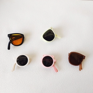 Detailed top view of various colorful foldable sunglasses for kids in five distinct styles