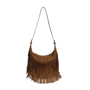 Brown faux suede hobo bag with bohemian fringe and crossbody strap on white background