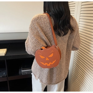Side view of a pumpkin-shaped crossbody bag worn by a model in a cozy interior