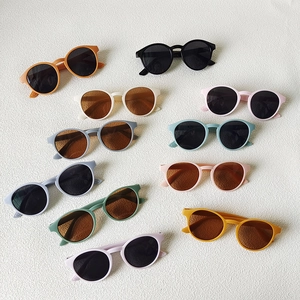 Children round retro sunglasses in 10 assorted colors displayed on textured white background