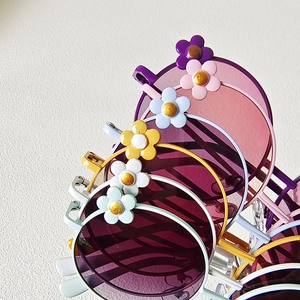 Close-up of retro flower round frame sunglasses for kids in various vibrant colors