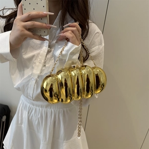 Golden acrylic caterpillar box clutch with metallic mirror finish and chain strap
