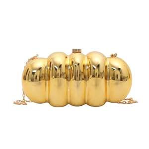 Glossy gold caterpillar acrylic evening clutch bag with vertical striped design and chain