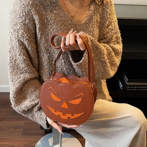 Quirky pumpkin-shaped crossbody bag with jack-o-lantern face for Halloween fashion