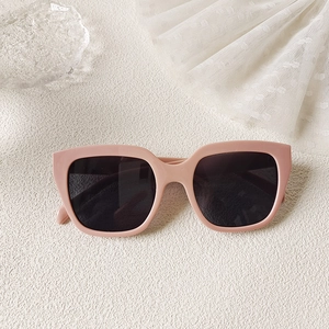 Detail of pink square sunglasses with matte frame on aesthetic textured surface