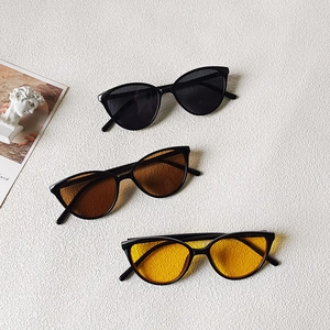 Three pairs of triangle cat-eye sunglasses for kids with black frames and colored lenses