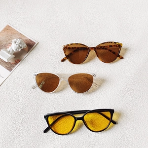 Three pairs of triangle cat-eye sunglasses for kids in tortoiseshell and clear frames