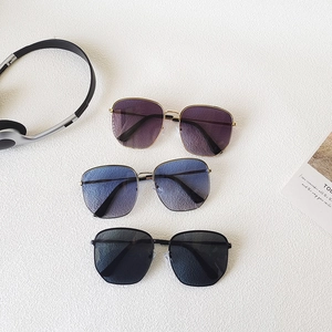 Three pairs of oversized metal sunglasses in purple, blue gradient and classic black