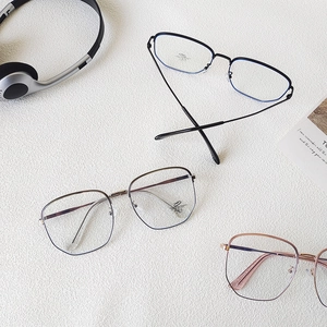 Three minimalist metal anti-blue light glasses in black, silver, and rose gold frames