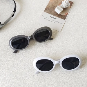 Retro oval sunglasses with gray and white plastic frames and dark UV protection lenses
