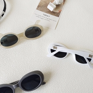 Retro oval sunglasses in white and grey with double B metal logo on a minimalist background