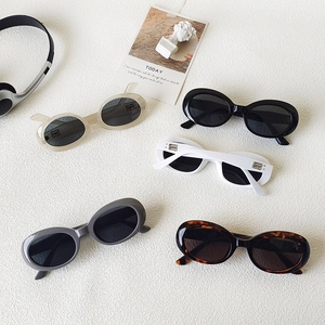Retro oval sunglasses with BB logo in five colors on a marble stone background
