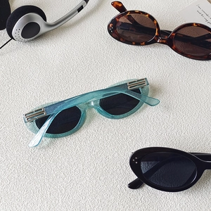 Retro oval cat-eye sunglasses in glitter blue, tortoise shell, and classic black frames