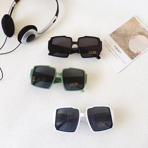 Three pairs of vintage square kids sunglasses in black, green, and white with UV400 lenses