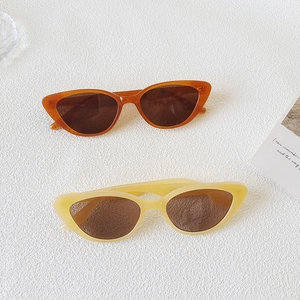 Vintage cat eye sunglasses in amber and cream yellow colors on a white background