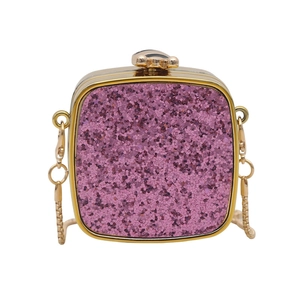 Detail of pink sequin mini bag featuring gold metal frame and animal shaped clasp