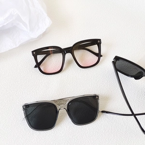 Detail of square oversized sunglasses with gradient lenses and star metal rivets