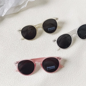 Three pairs of kids polarized round sunglasses with UV400 labels on white background