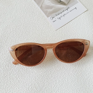 Detail view of vintage champagne cat-eye sunglasses with dark brown polarized lenses