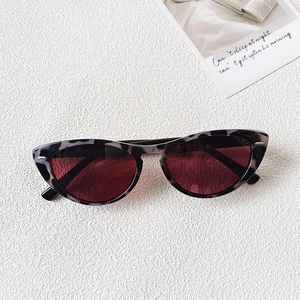 Close-up of tortoise shell cat-eye sunglasses with silver diamond metal decorations