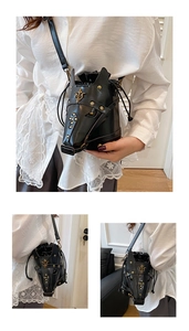 Detailed close-up of horse head crossbody bag with gold studs and drawstring closure