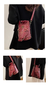 Detailed close-up of a burgundy horse head crossbody bag with gold crown rivets