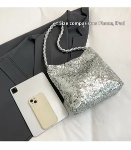 Silver sequin shoulder bag shown with phone and iPad for size comparison detail