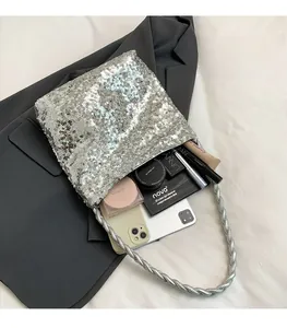 Detail view of silver sequin handbag interior showing spacious capacity for cosmetics