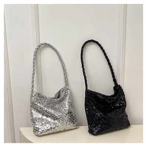Close-up of silver and black sequin bucket bags with woven handles and shiny texture