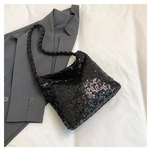 Detail of black sequined bucket bag with a stylish thick twisted rope shoulder strap