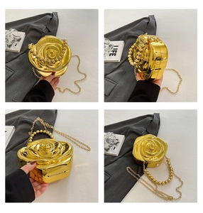 Detail of gold rose-shaped evening bag featuring beaded handle and metallic chain strap