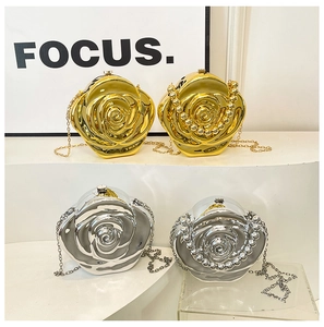 Close-up of golden and silver rose-shaped evening clutch bags with metallic floral texture