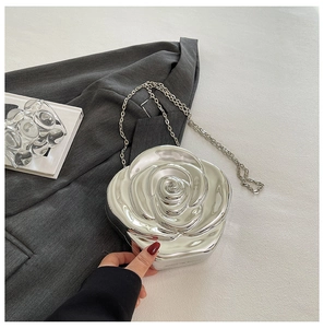 Detailed macro view of 3D silver rose acrylic clutch with metallic mirror finish