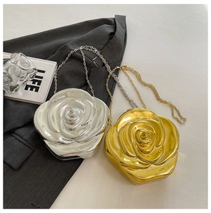 Detailed macro view of 3D rose acrylic evening clutches in gold and silver finishes